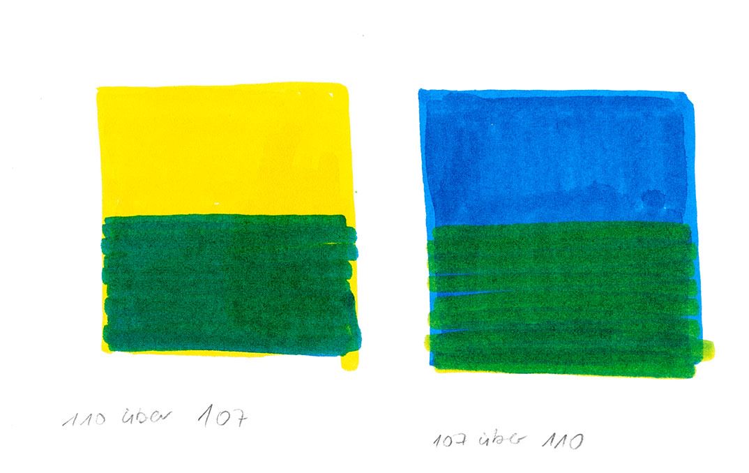 Yellow and green colour painted in a squared box next to blue and green colour in a box.