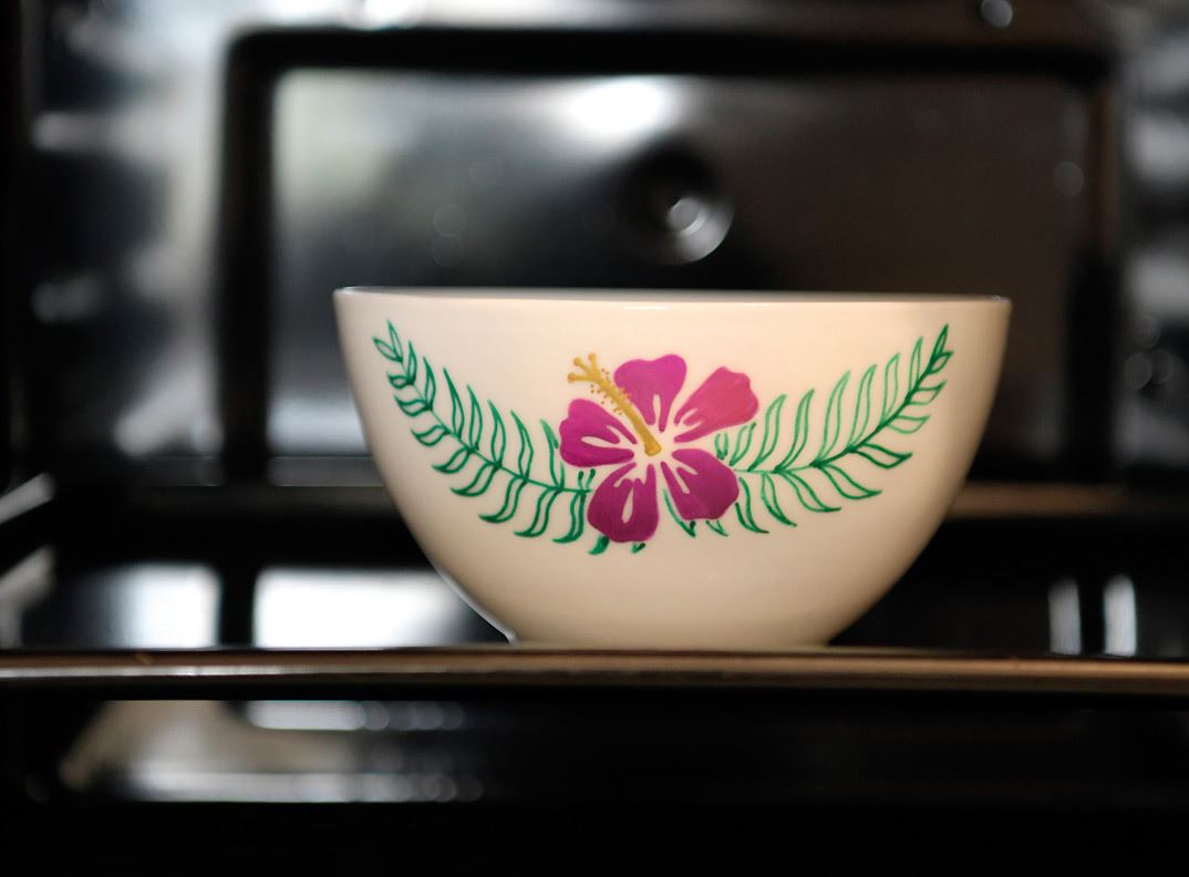 An embellished bowl in an oven.