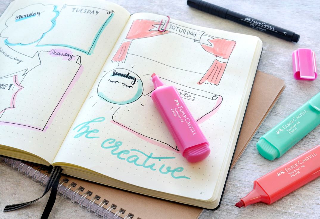 Bullet journal "be creative" with textmarkers in different colours and a black pitt artist pen